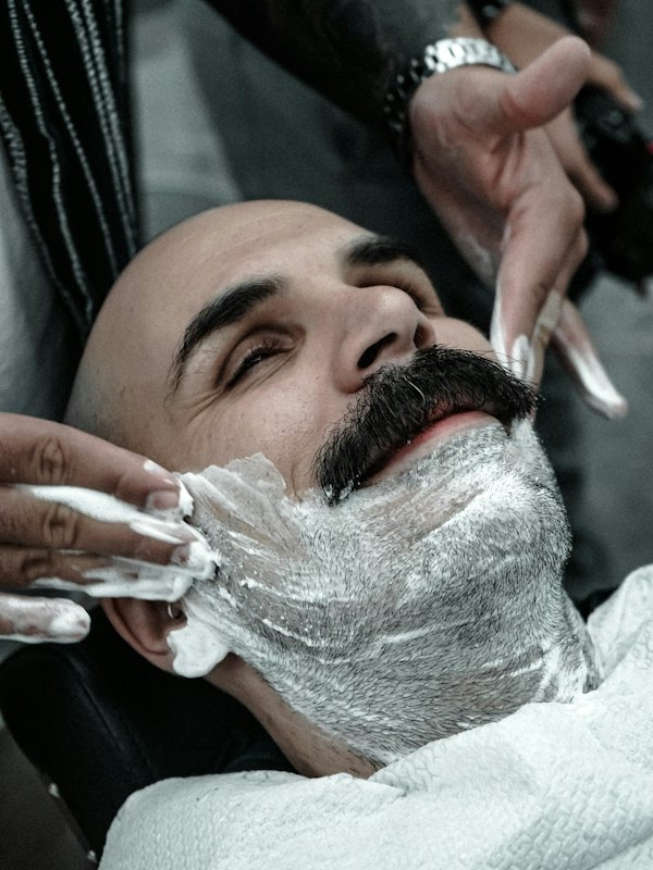 Barba sendo feita com espuma e navalha